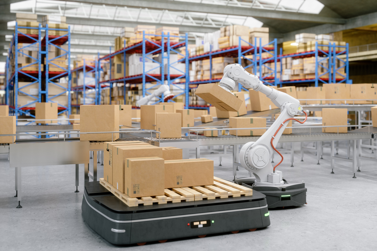 Automated Robot Carriers And Robotic Arm In Modern Distribution Warehouse