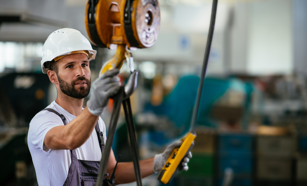 Worker in factory using lifting beam